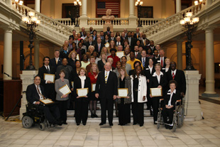  A picture of people posing for an award. 