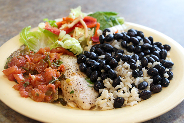 Fish with tomato, beans, and salad.