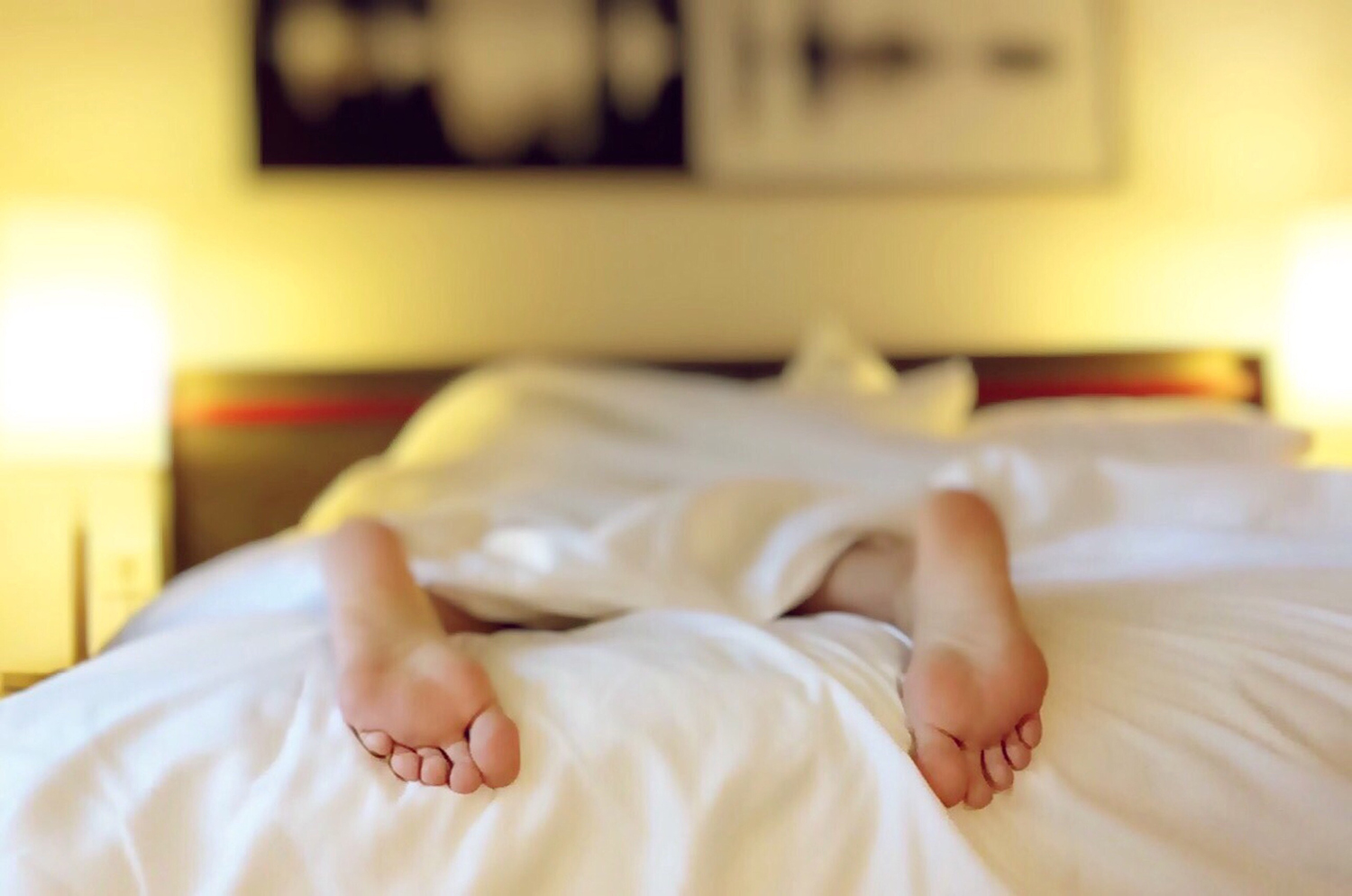 Image of feet in bed.