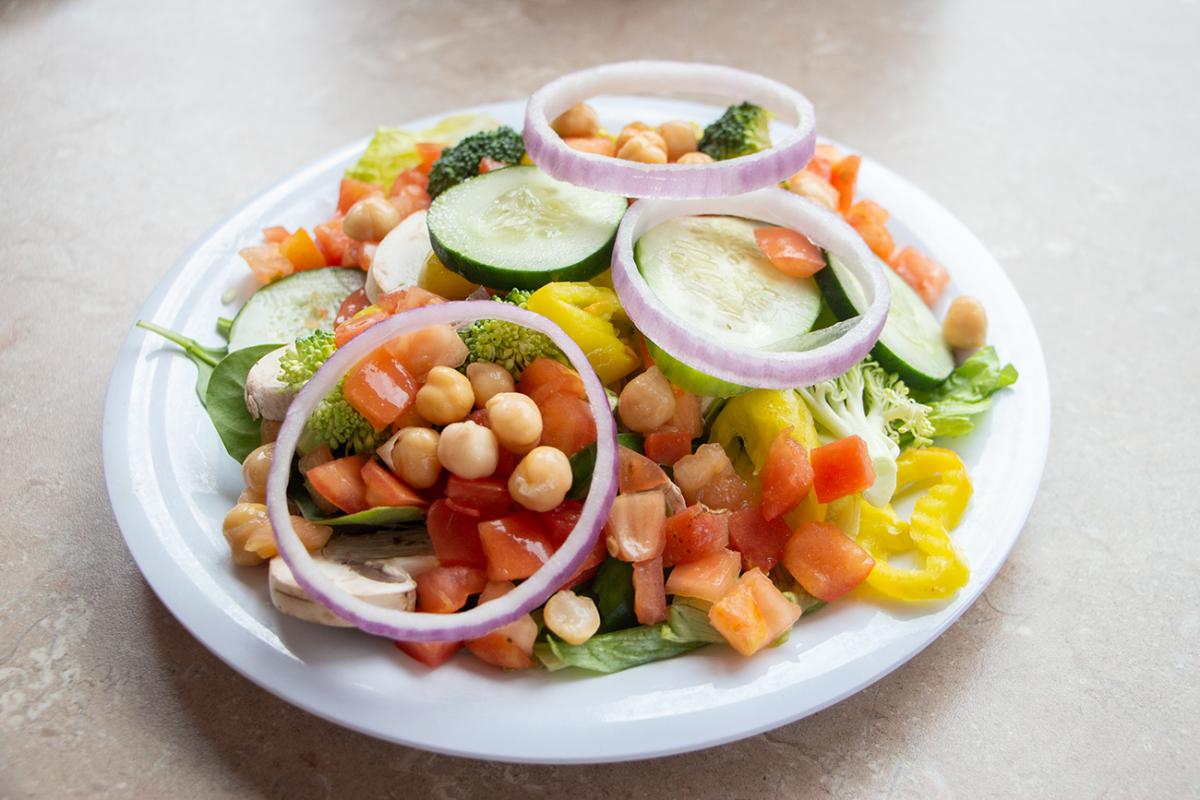 A picture of a salad with various toppings. 