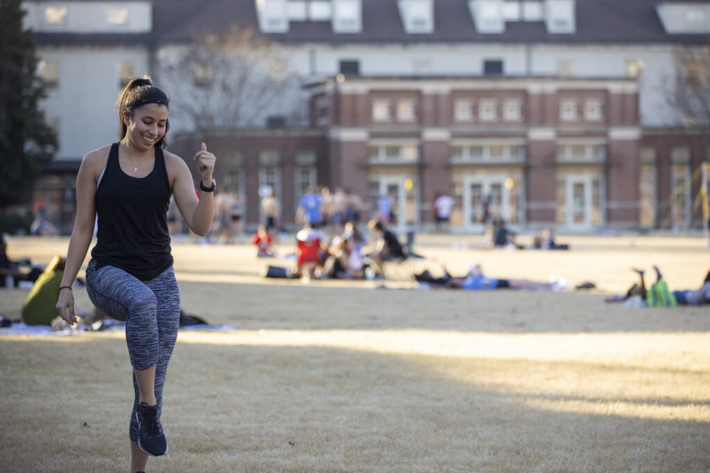 Rec Sports graduate assistant for fitness and wellness Montse Molas leads a dance-based pop-up fitness class on Myers Quad.