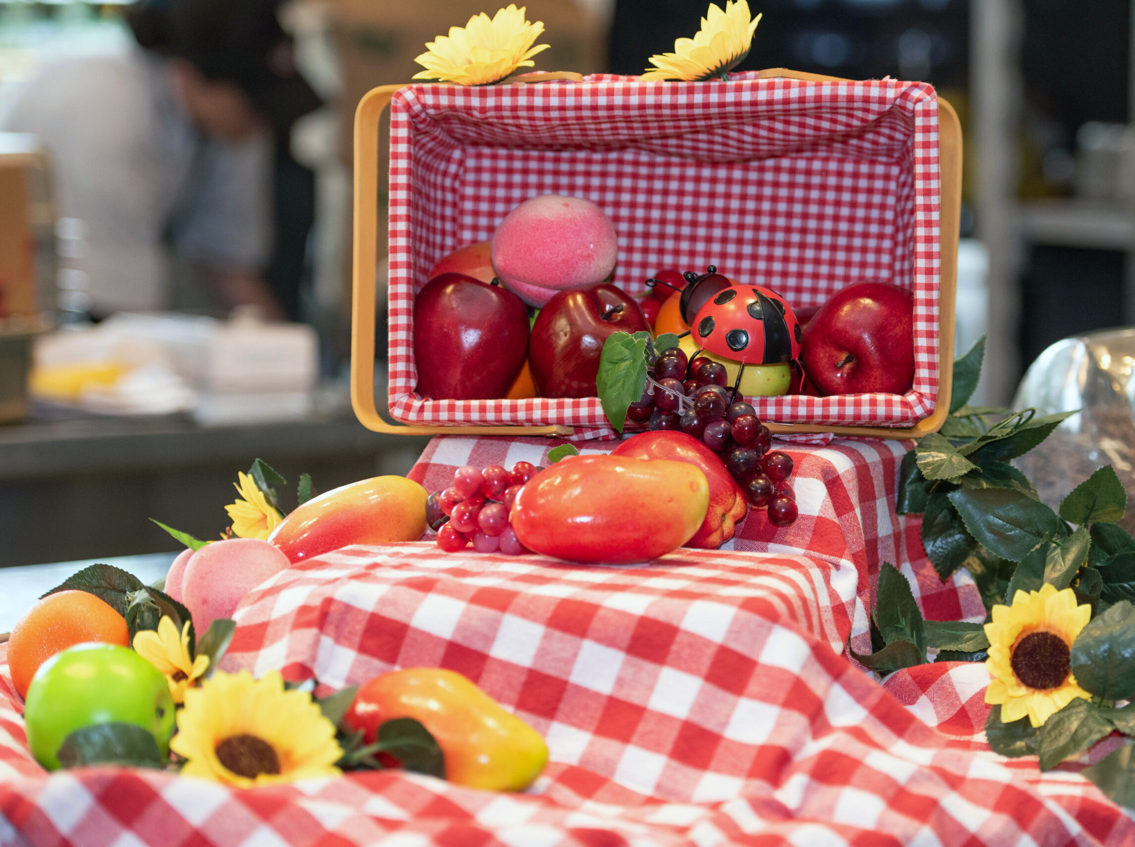 Picnic basket with fruit and flowers.